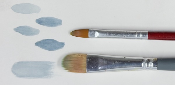 2 filbert brushes of different sizes and shapes along with the marks they make