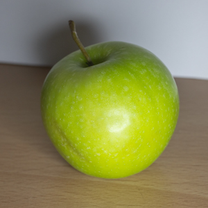 Photo reference example: An apple lit from the front, appearing bright but lacking strong form shadows.