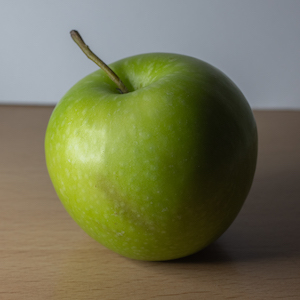 Photo reference example: The same apple lit from the side, revealing its 3D shape with clear light and shadow patterns.