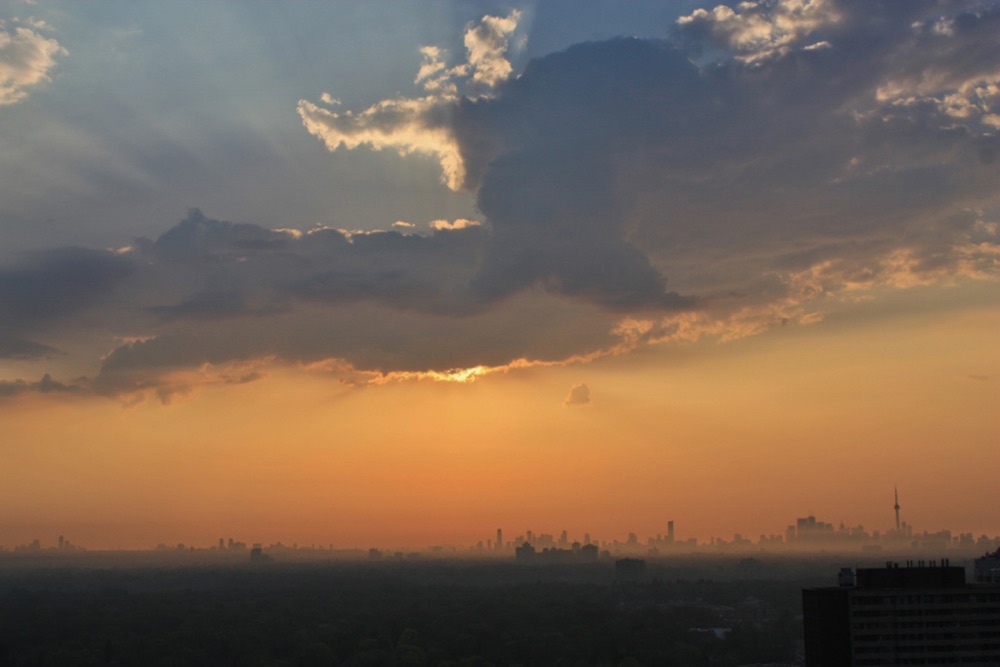 Sunset sky reference photo, glow breaking under a bank of cloud