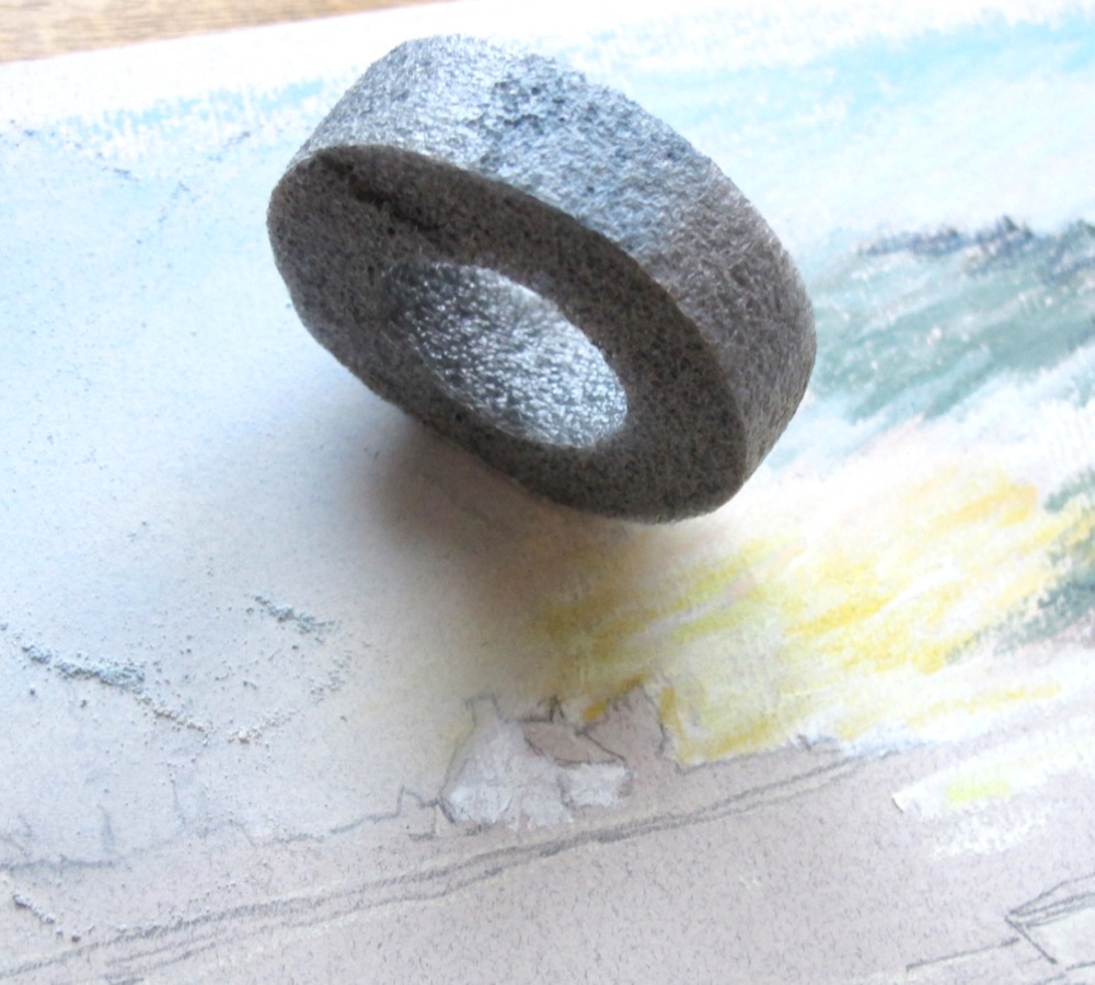 A piece of foam pipe insulation being used to blend the pastel sky in small circles