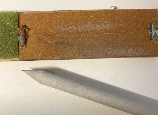 A blending stump with a sandpaper sharpener A blending stump with a sandpaper sharpener