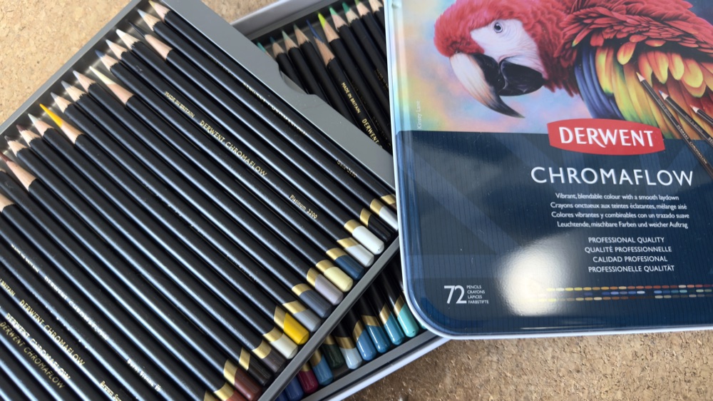 Open tin of Derwent Chromaflow coloured pencils with the 72-set lid showing the parrot artwork