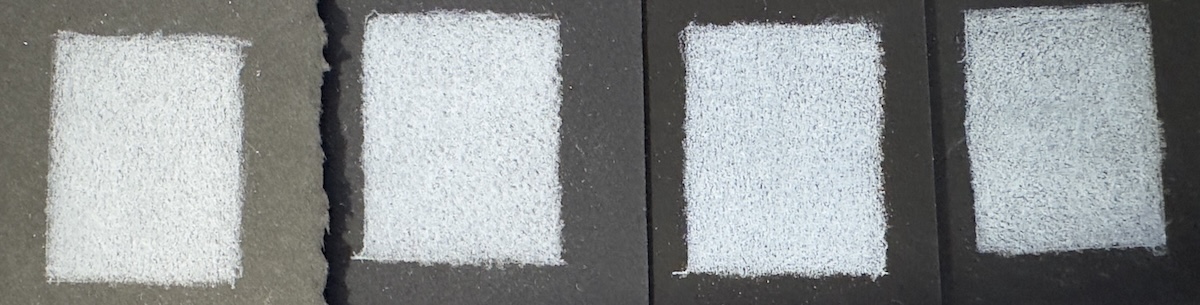 The same white Chromaflow pencil swatched in five layers on four different black papers, shown side by side for comparison