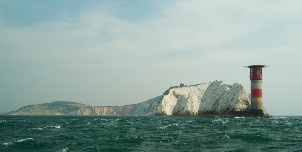 Close reference photo of the Needles rocks and lighthouse at Alum Bay seen from the sea
