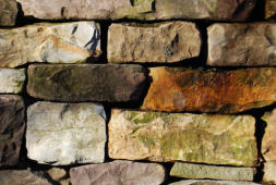 Wall built of multi-colored stones Wall built of multi-colored stones