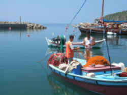 small fishing boat partly disappearing into the water