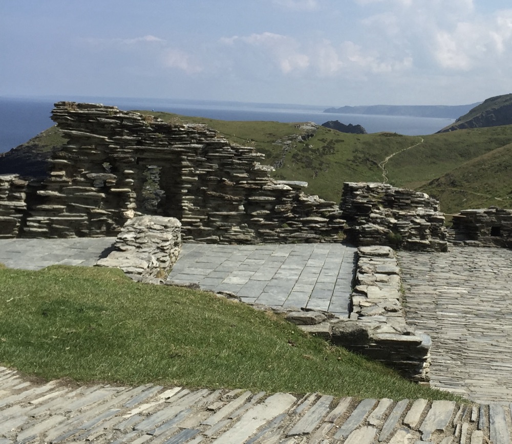 Dry-laid slate walls at Tintagel running through open coastal hillside