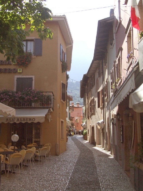 Reference photo of a sunlit Italian street scene in Malcesine, Lake Garda