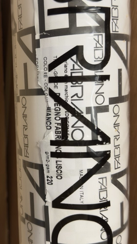 Close-up of a roll of Fabriano Liscio smooth white drawing paper, 220 gsm, in its printed plastic wrapper