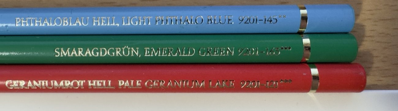 Three Faber-Castell Polychromos pencils showing the lightfastness star rating stamped on each barrel