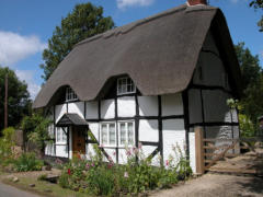 Thatched cottage with a patterned ridge line along the crown
