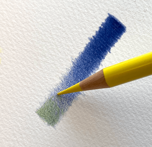 Yellow coloured pencil layered over a blue pressure test